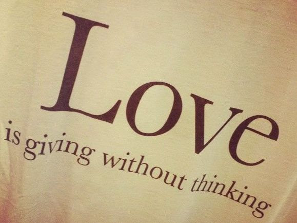 Brown background with the text "LOVE is giving without thinking"