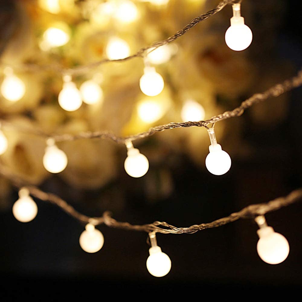An image of white ball like Christmas lights set against a dark background.