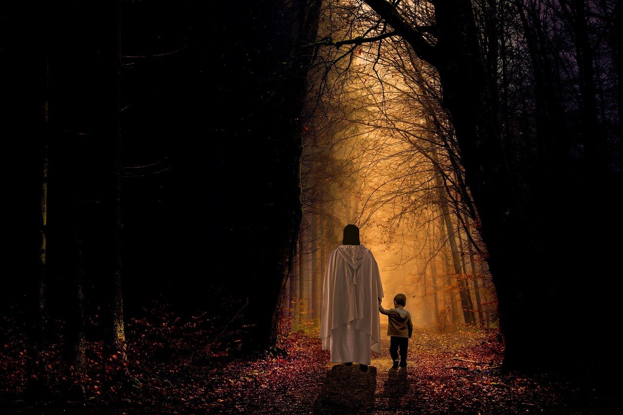 An image of Jesus walking hand in hand with a child through the woods.